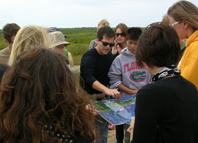 [Marty Hylton (center), the new director of DCP’s program in Nantucket, Mass., reviews a project site with his students.]